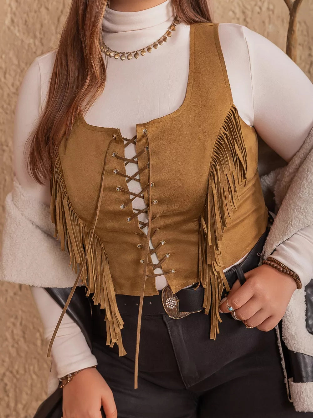 Caramel faux suede vest with fringe and lace-up front, cropped length.