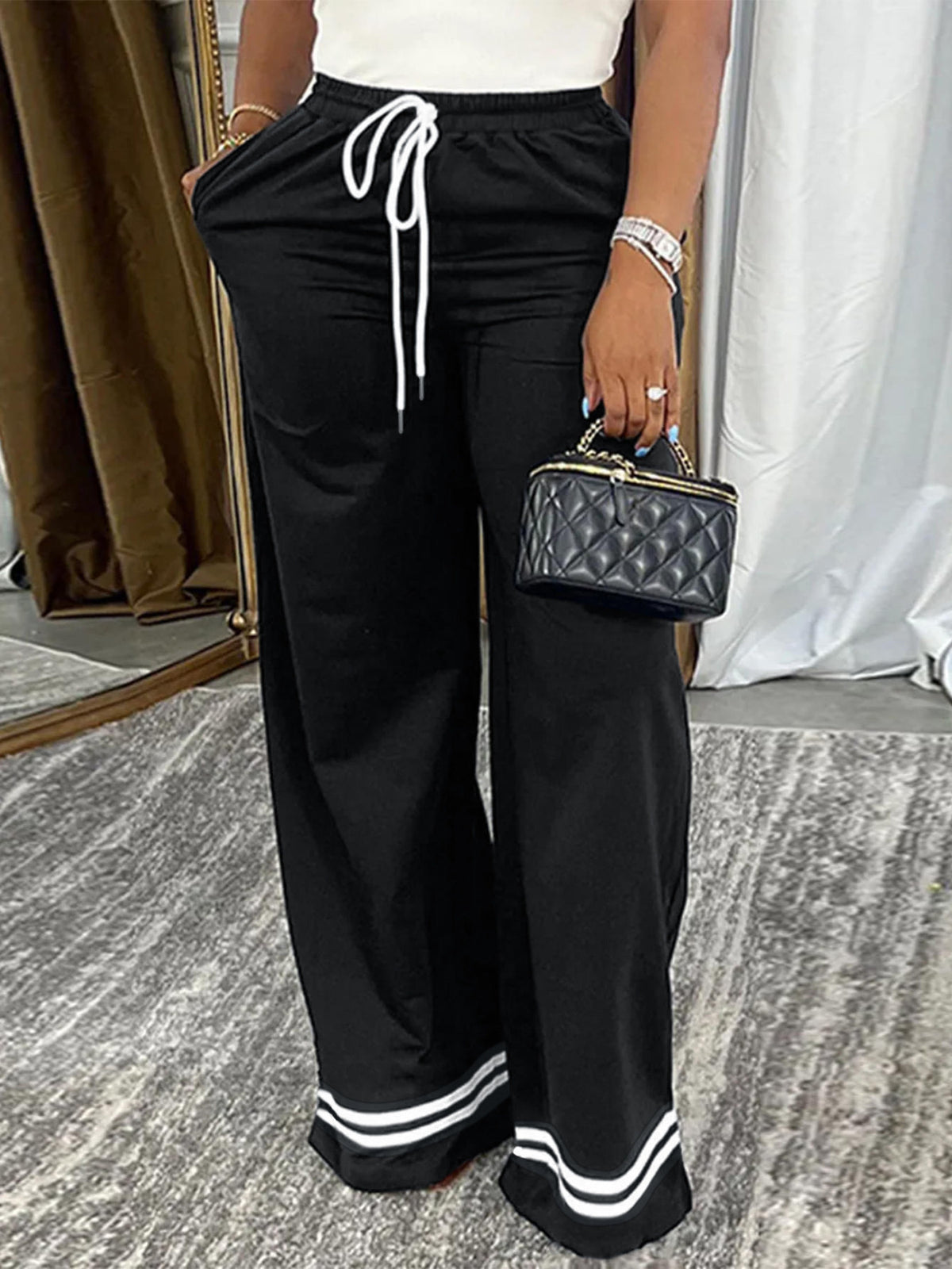 100% polyester Care instructions: Machine wash cold wide-leg pants in black with wide-leg silhouette