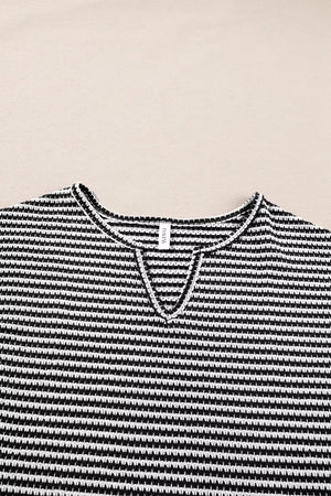 Textured knit t-shirt with black and white stripes and a notched V-neck.