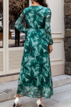 V-neck wrap maxi dress in green botanical print, long sleeves, elastic waist, flowy skirt.