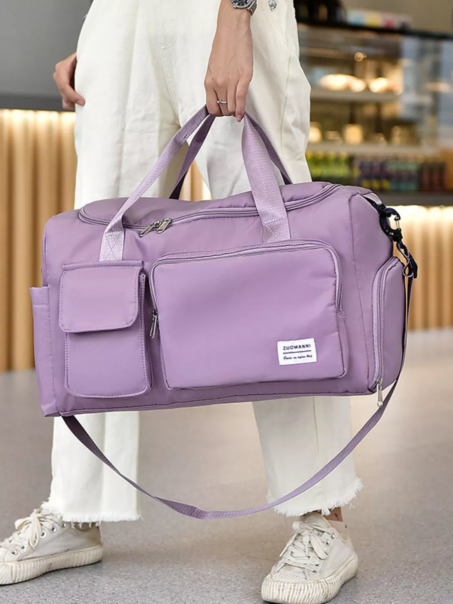 Purple Oxford cloth travel bag with multiple pockets and detachable strap.