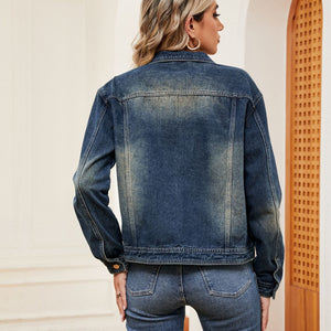 Faded wash denim trucker jacket with classic collar and button cuffs.