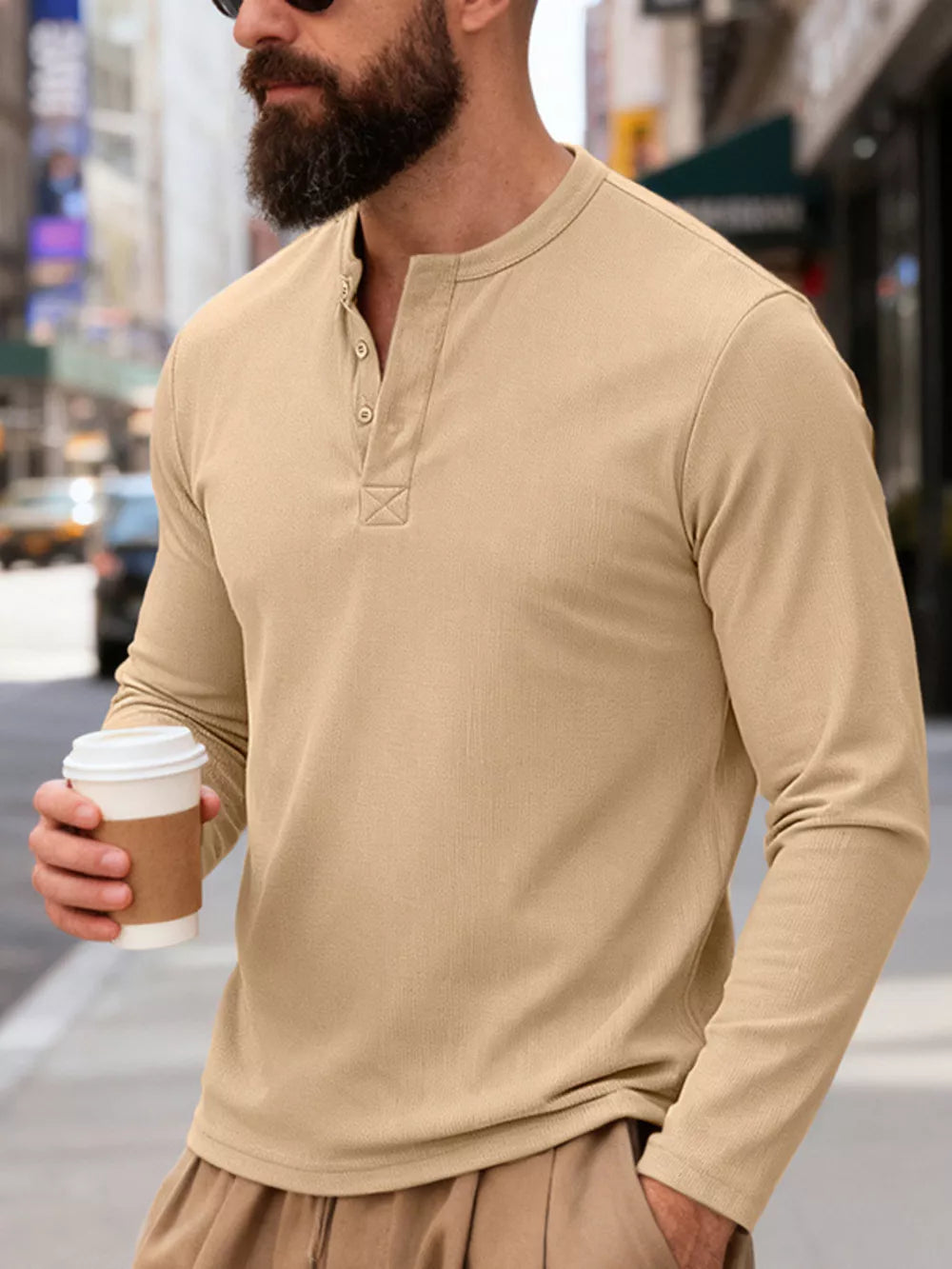 Men's Khaki long sleeve Henley t-shirt with button placket and textured fabric.