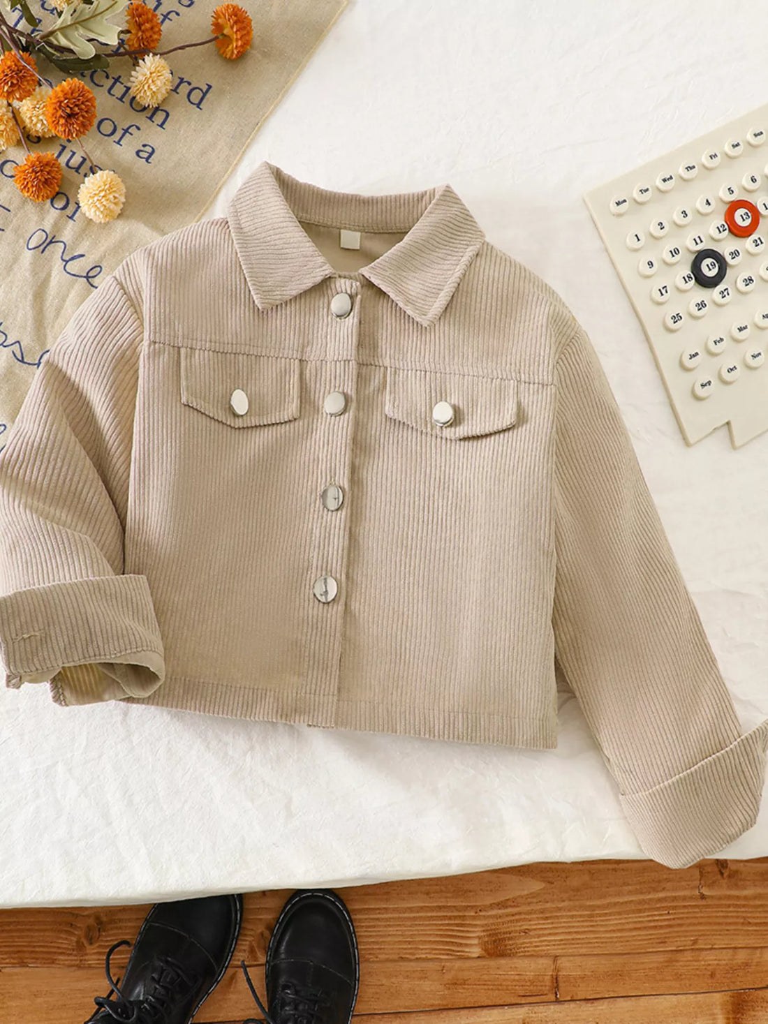 Casual tan corduroy button-up jacket with two chest pockets and silver buttons.