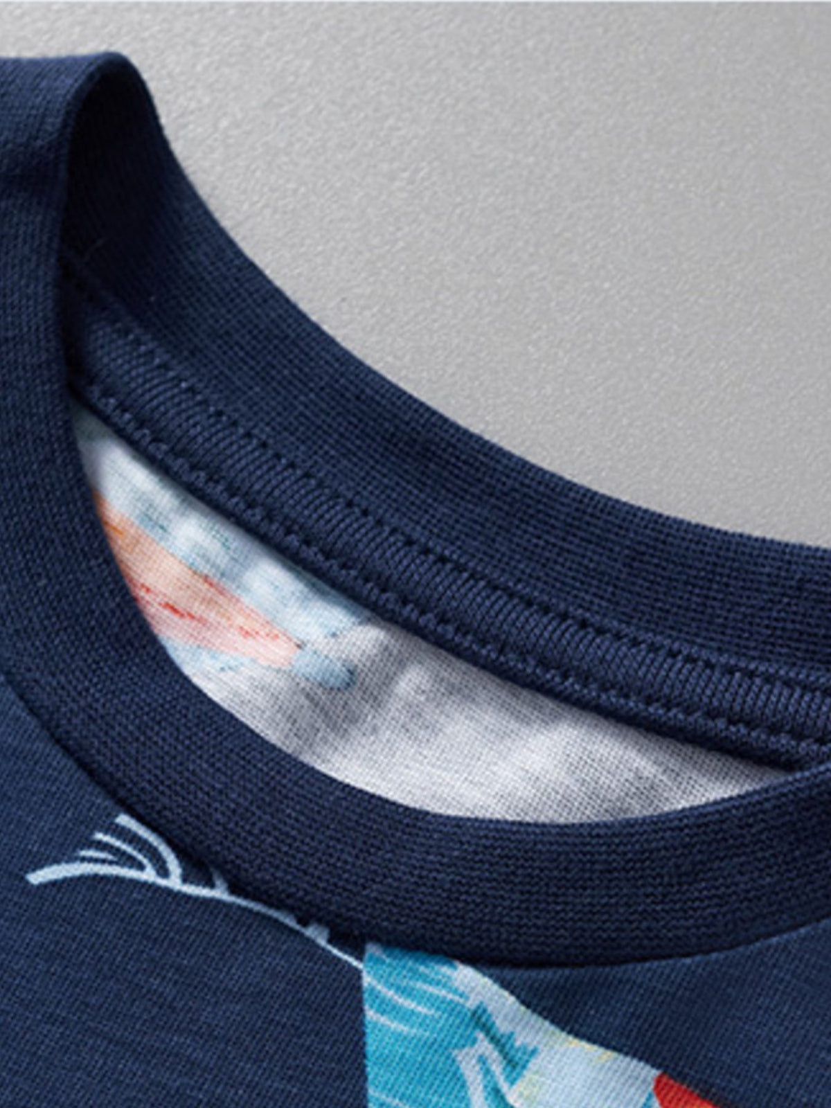 Navy cotton toddler boys' t-shirt with colorful tropical print and ribbed neckline.