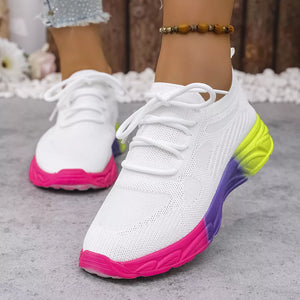 White mesh lace-up sneakers with pink, purple, and yellow gradient soles.