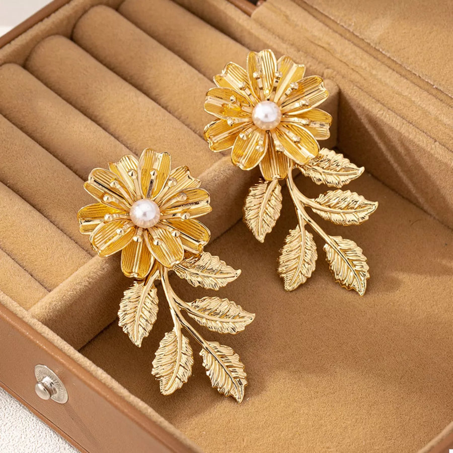 Golden floral drop earrings with pearl centers and leaf accents, 18K gold-plated.
