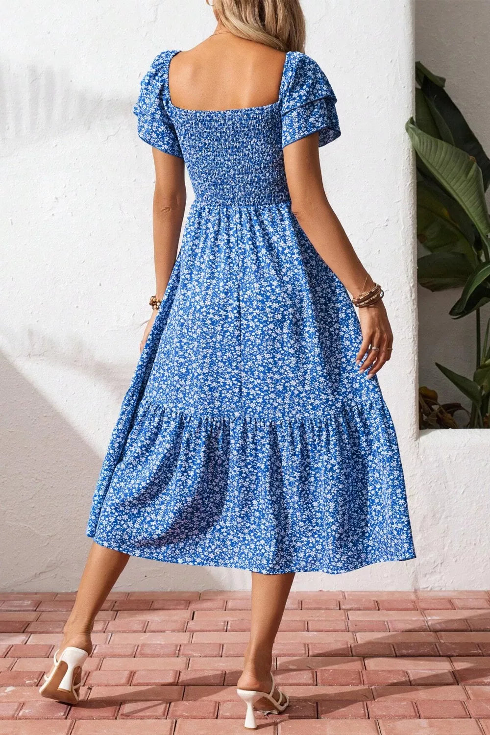 Blue floral smocked square neck dress with tiered skirt and short puff sleeves.