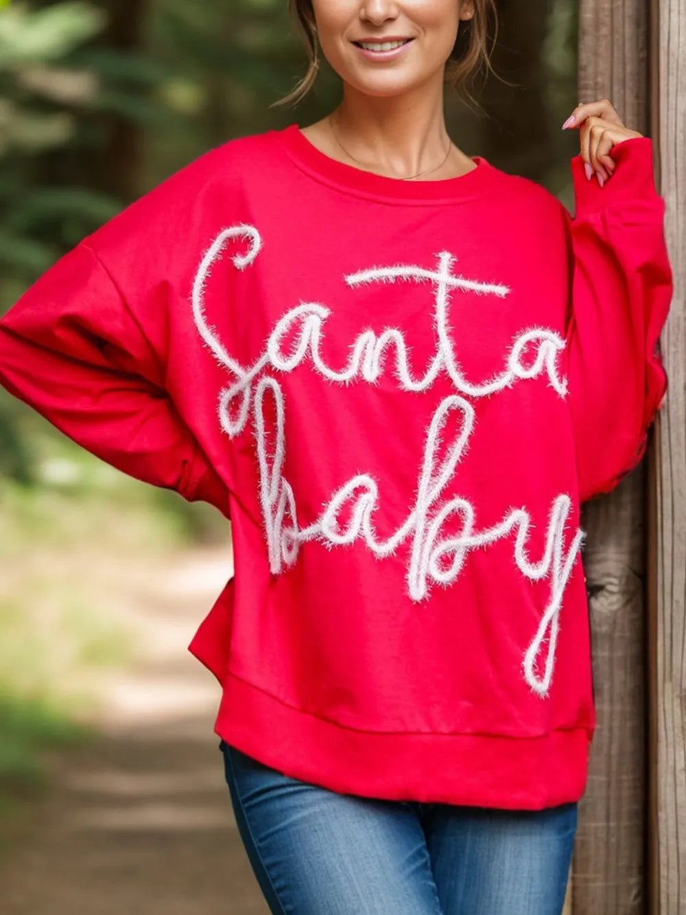 Red crewneck sweatshirt with white fuzzy Santa Baby embroidery