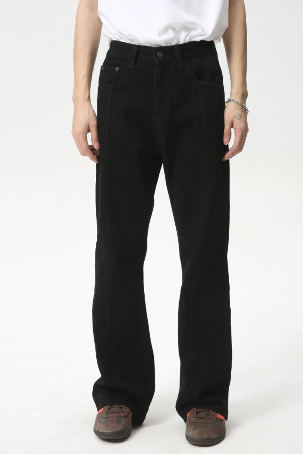 Black denim jeans with panel seams and a flare leg