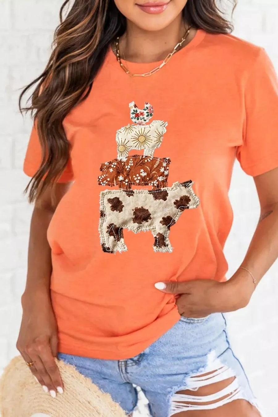 Orange t-shirt with stacked cow, sheep, and chicken applique graphic.