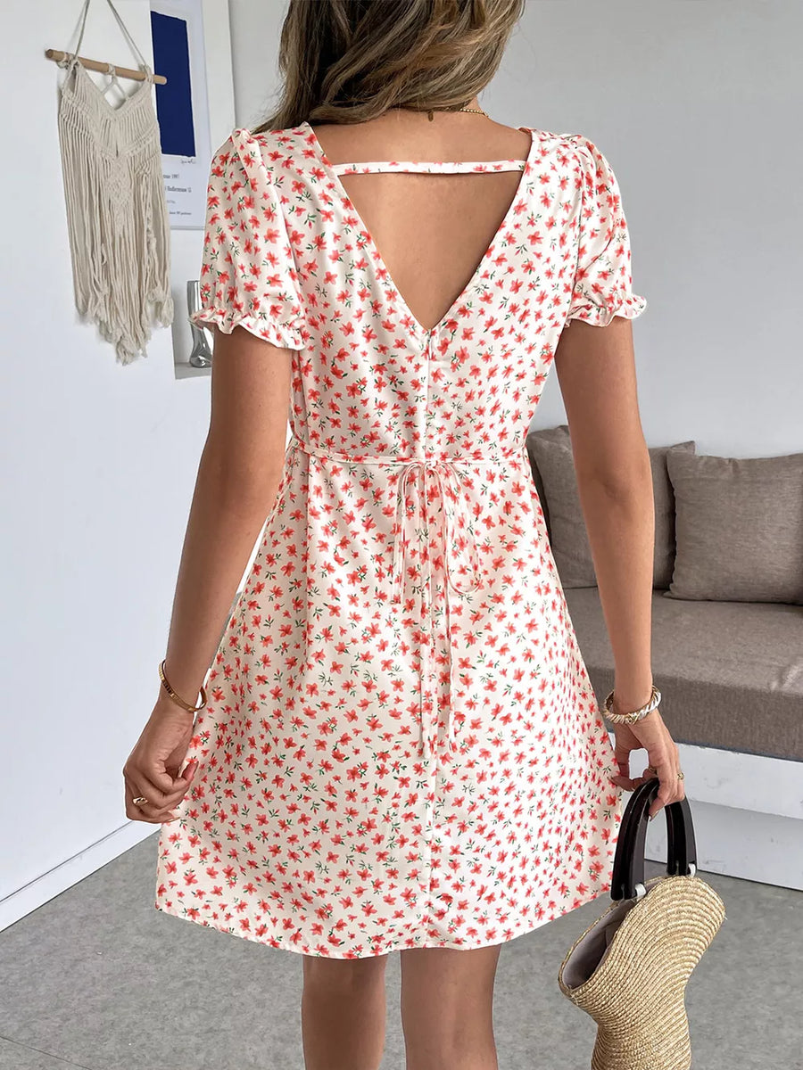 Floral V-neck mini dress with puff sleeves and a cutout back detail.