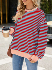 Striped crew neck sweatshirt in red and light blue with blush pink trim.