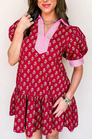 Red floral mini dress with puff sleeves, ruffled hem, and contrast trim neckline.