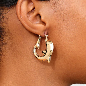 Gold dolphin hoop earrings with a sleek, polished finish.