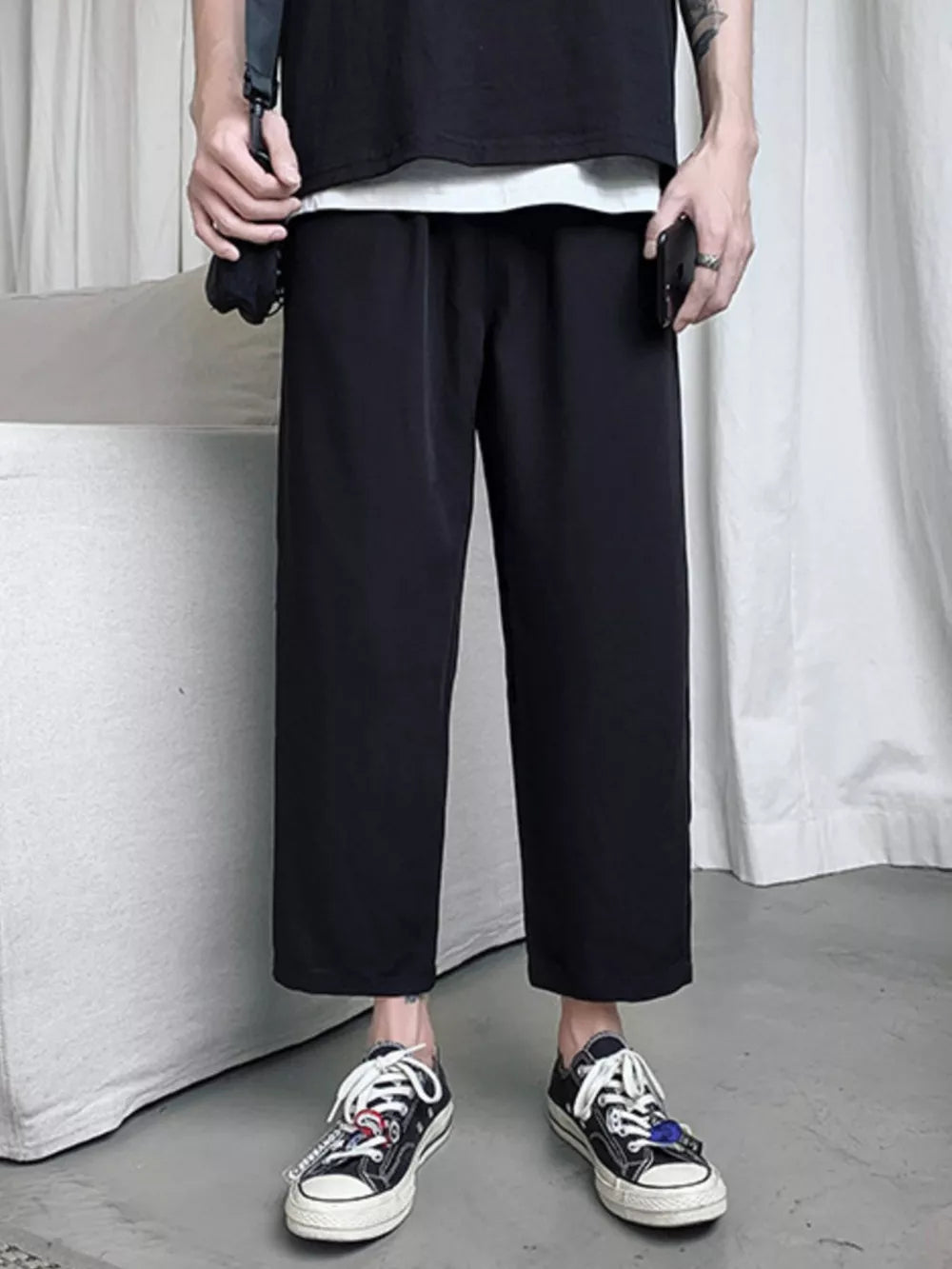 Men's black relaxed fit cropped sweatpants with drawstring waist and elastic cuffs.