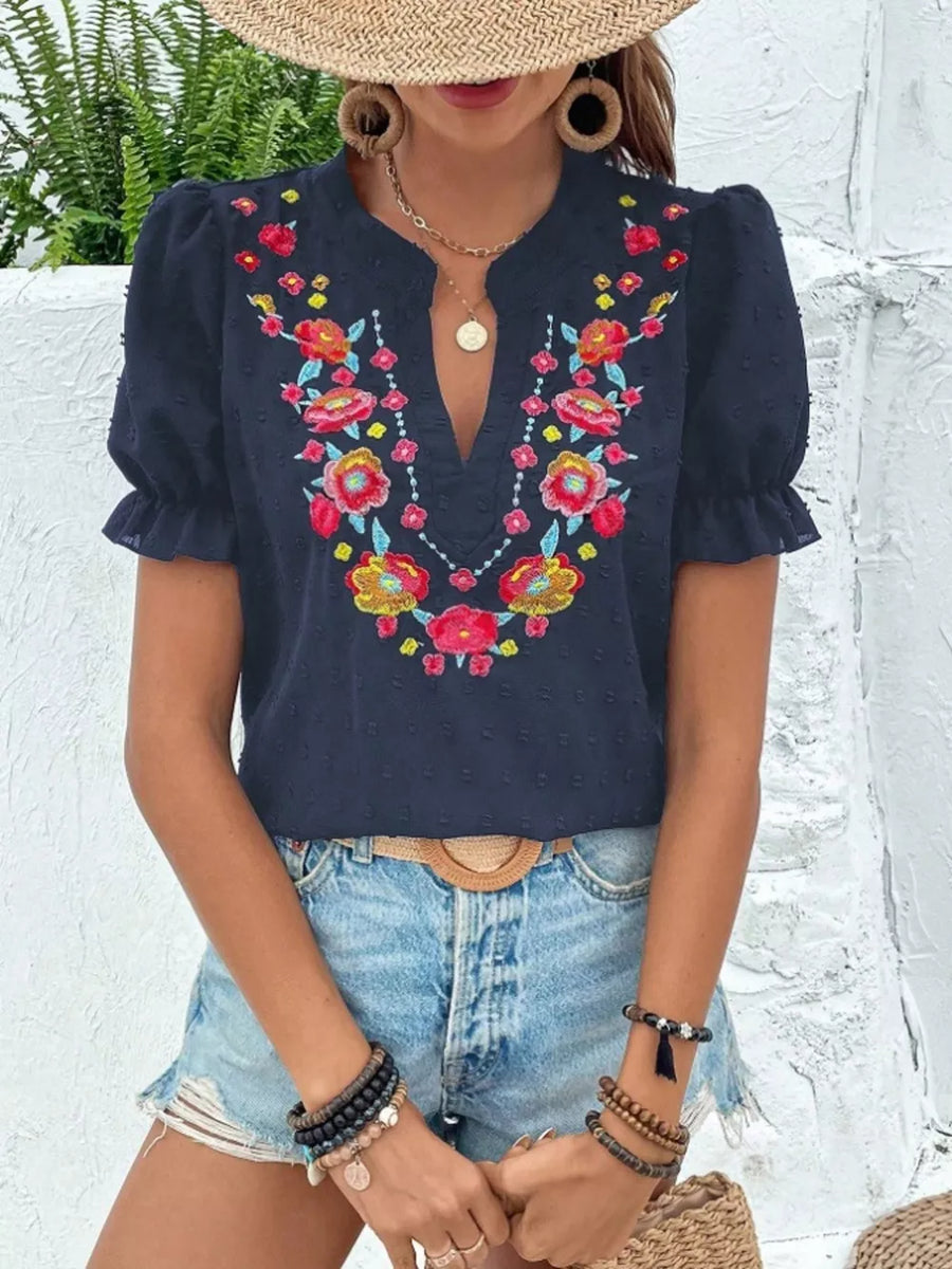 Navy blue embroidered blouse with puff sleeves and floral neckline detail