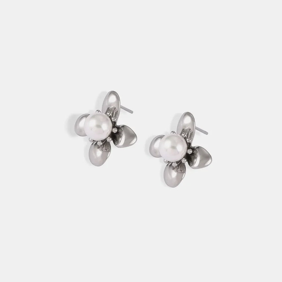 Silver petal pearl stud earrings with a floral design.