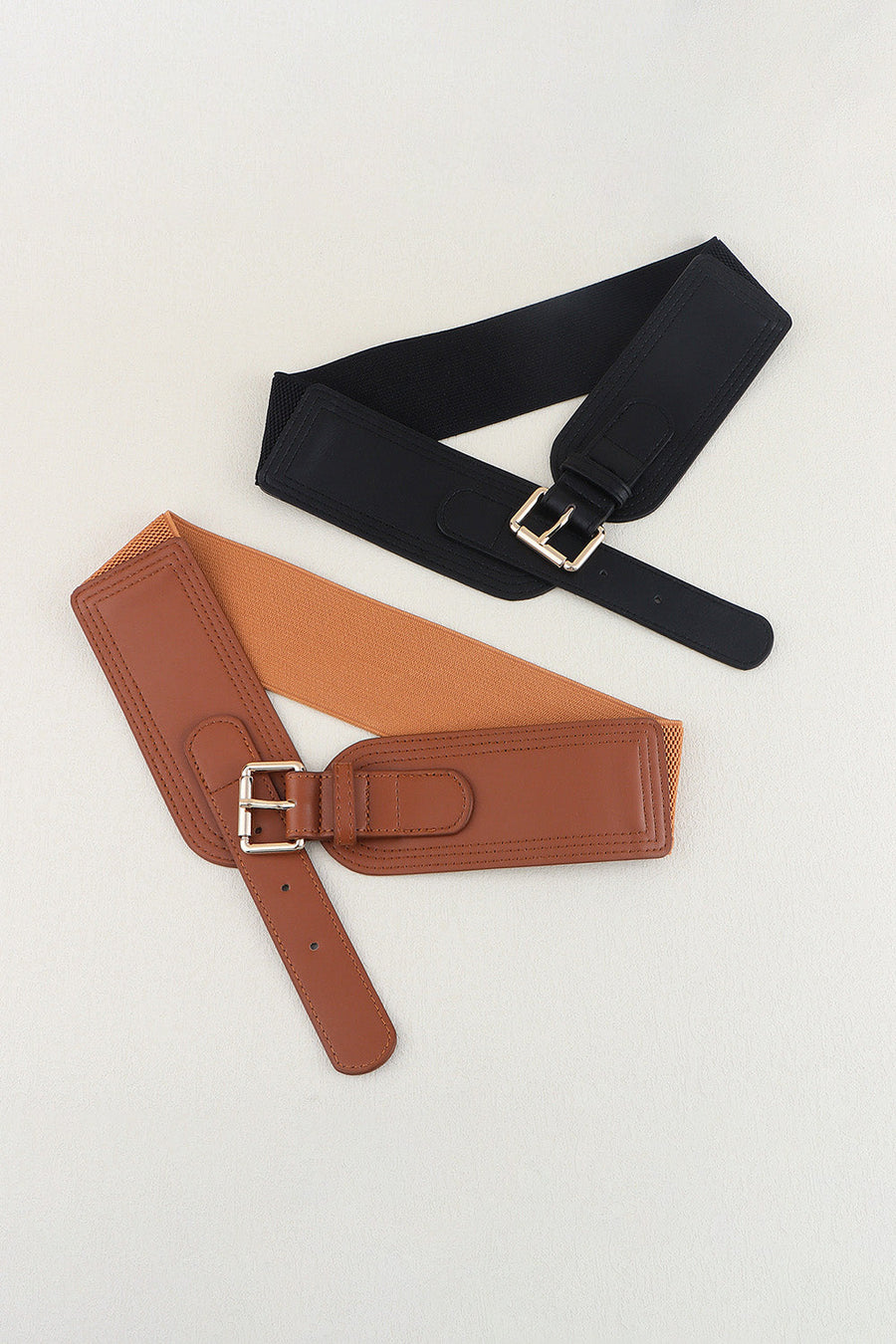 Black and caramel elasticated waist belts with faux leather fronts and silver buckles.