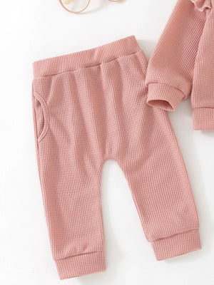 Toddler pink waffle knit pants with pockets and matching long sleeve top detail