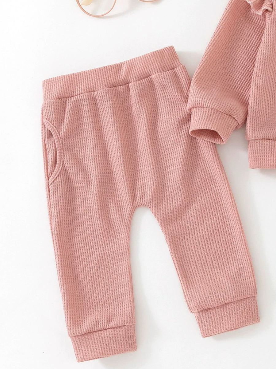 Toddler pink waffle knit pants with pockets and matching long sleeve top detail