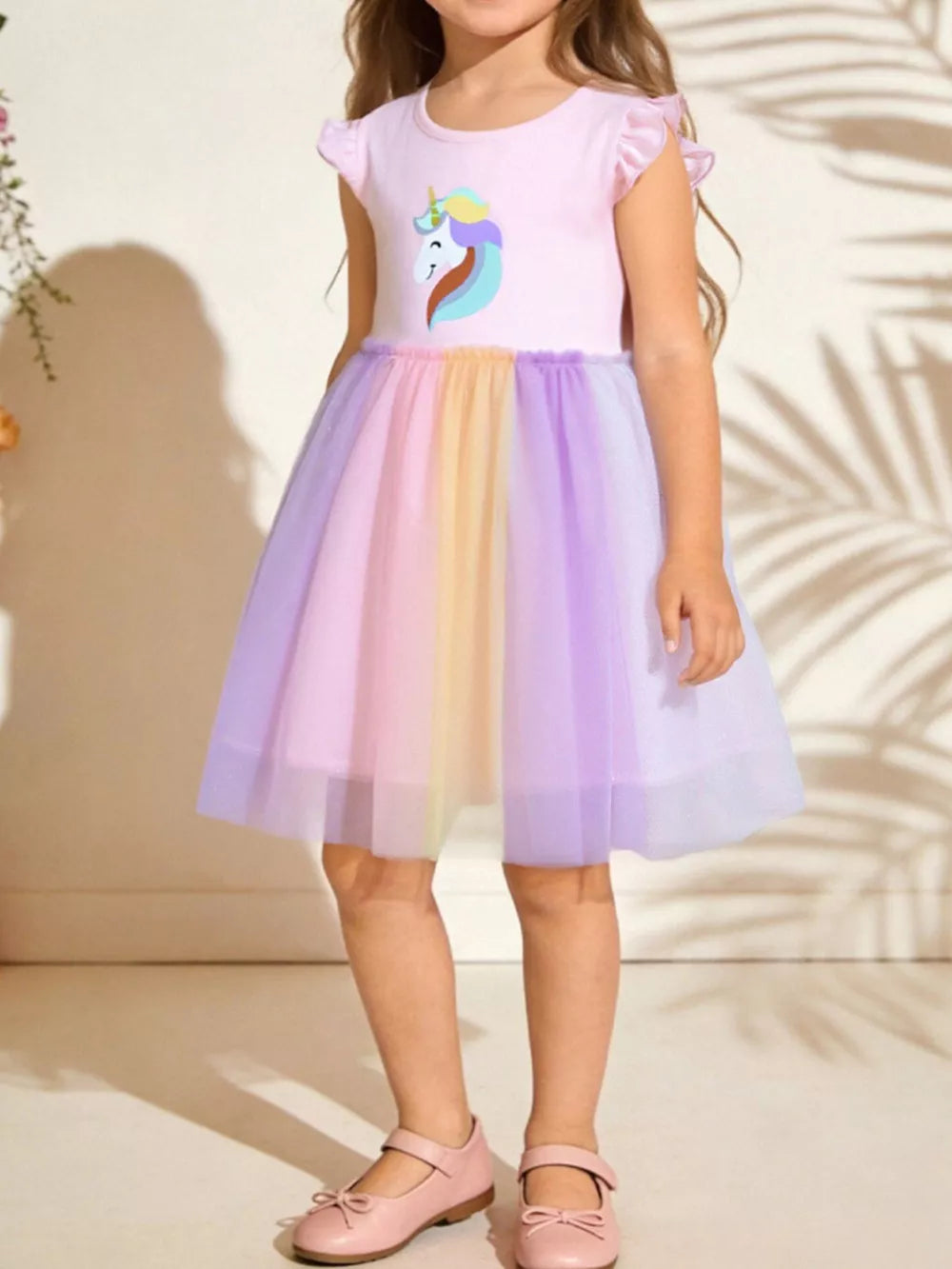 Baby girl's pink unicorn graphic tulle dress with rainbow skirt and flutter sleeves.
