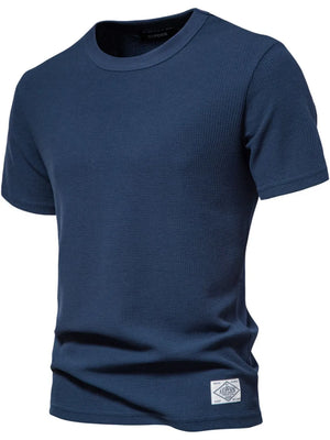 Navy textured crew-neck t-shirt knit with short sleeves and a hem tag.