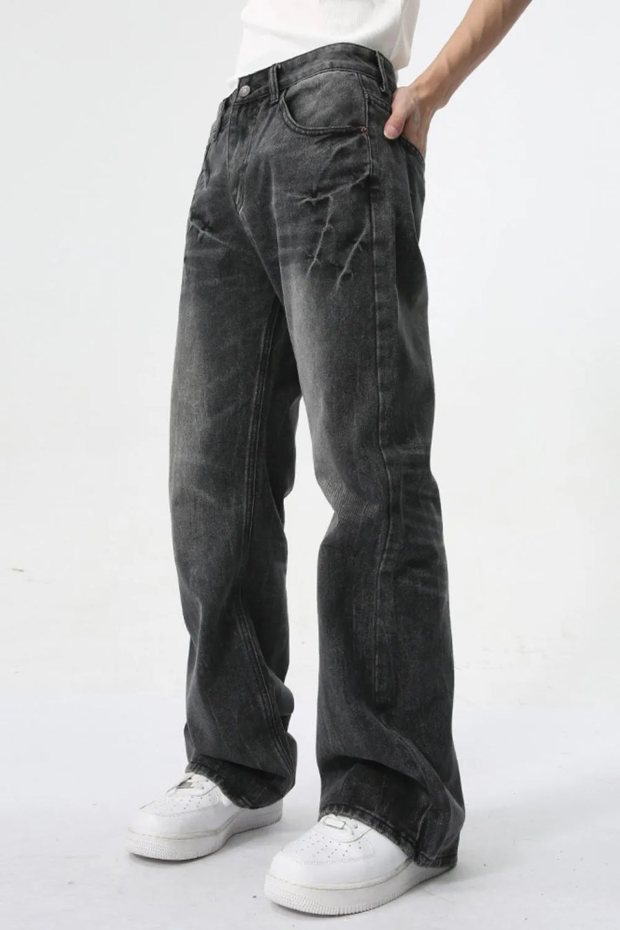 Washed black wide-leg denim jeans with a relaxed fit and distressed detailing.