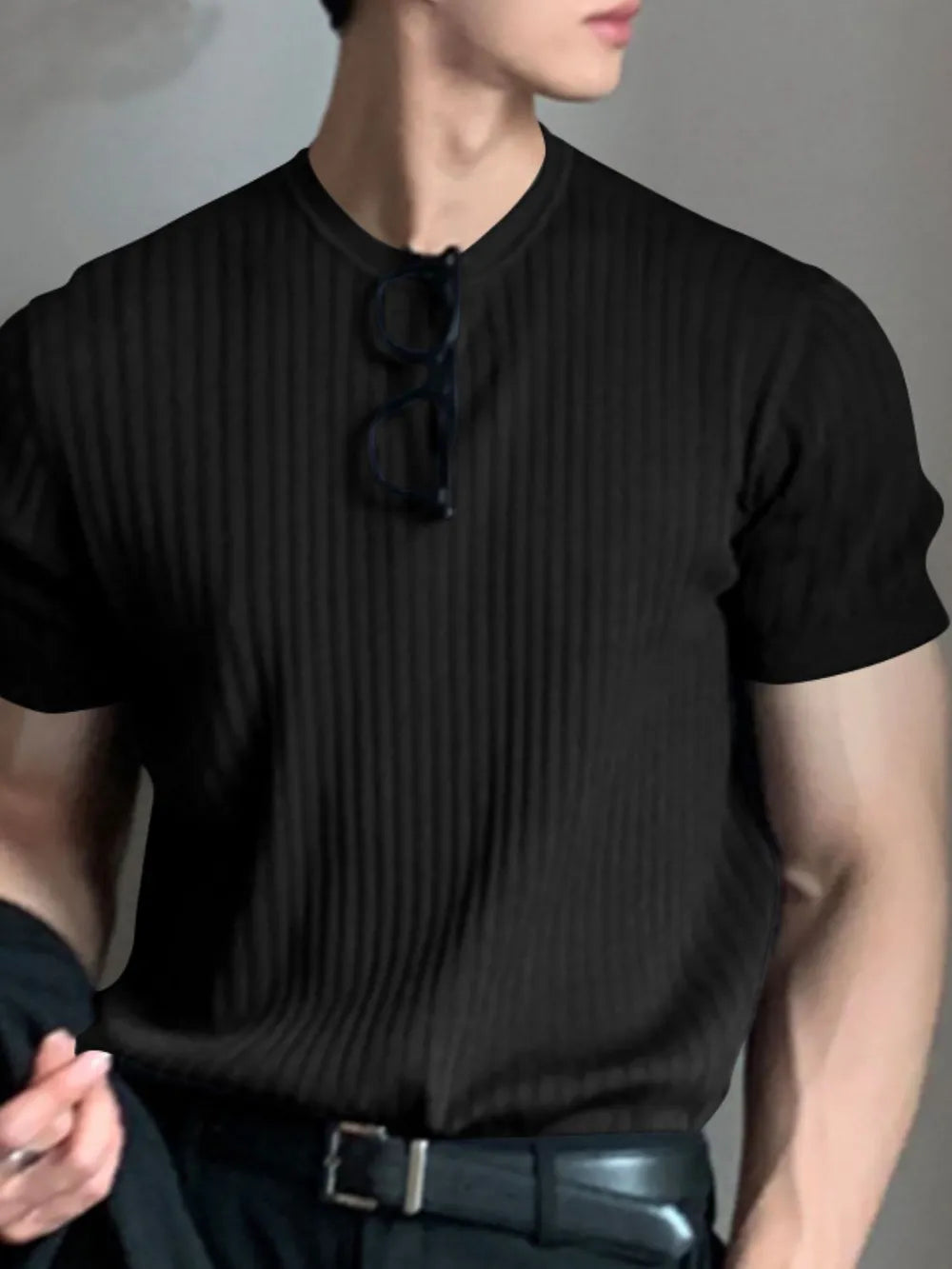 Black ribbed crewneck tee with short sleeves and a textured knit.
