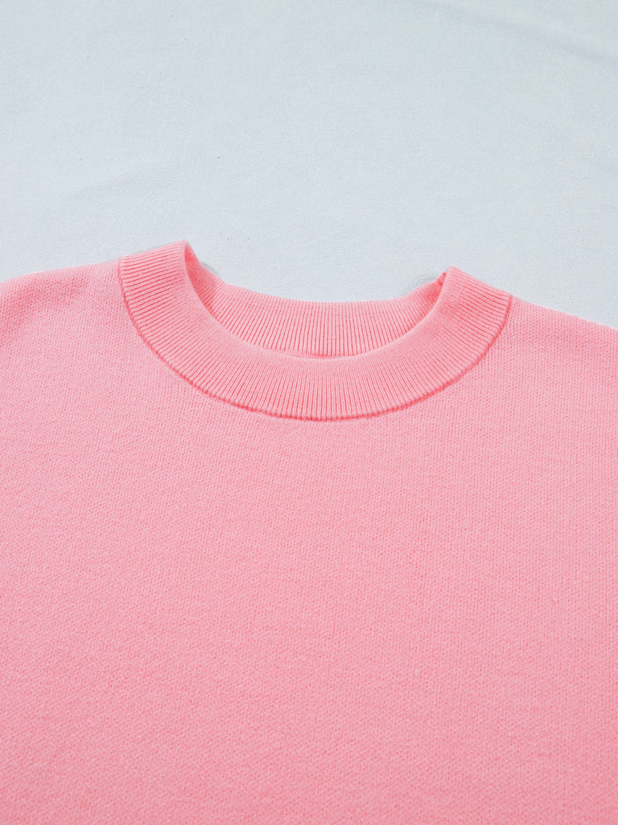 Pink knit top with crewneck and ribbed trim