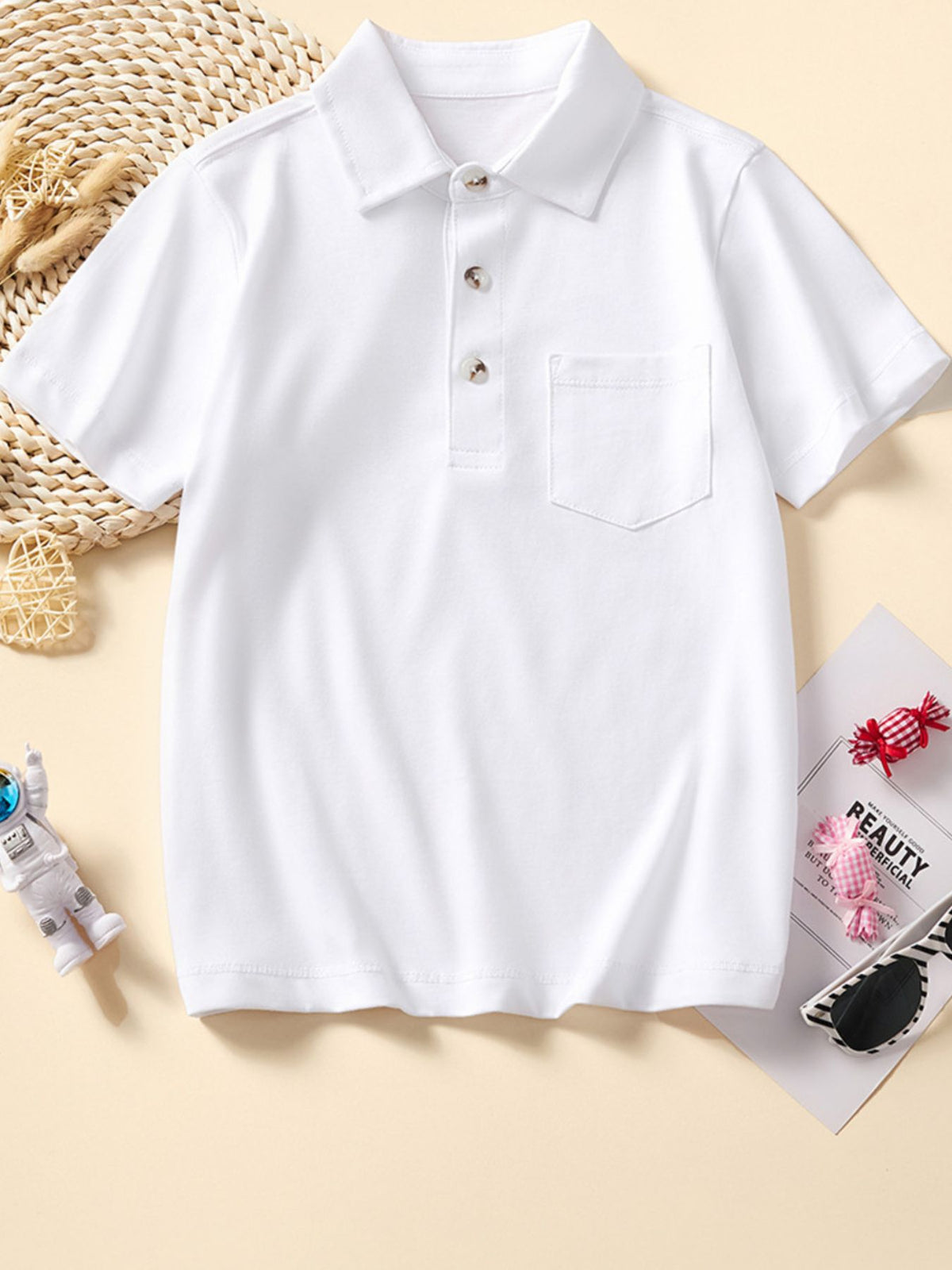 White cotton short sleeve polo shirt with buttoned placket and chest pocket.