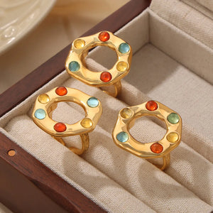 Gold statement ring with colorful gemstone halo detail