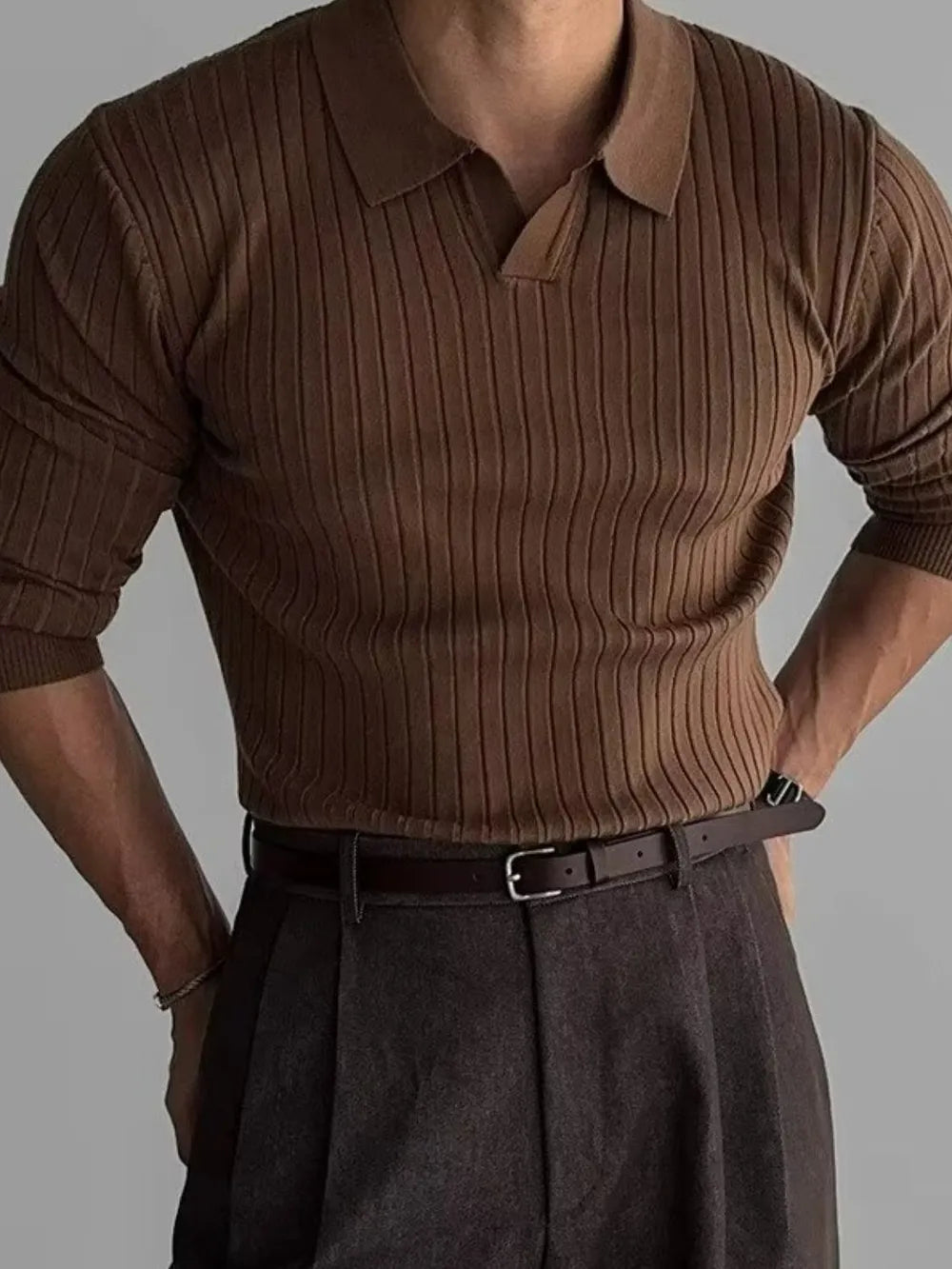 Brown ribbed knit polo shirt with a spread collar and long sleeves.