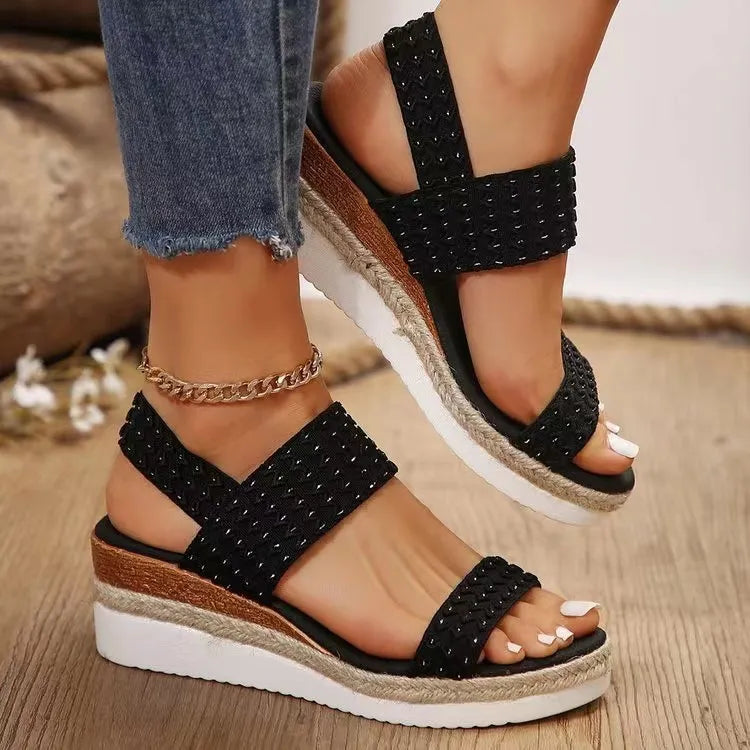 Black textured strap espadrille wedges with a platform sole and jute trim.