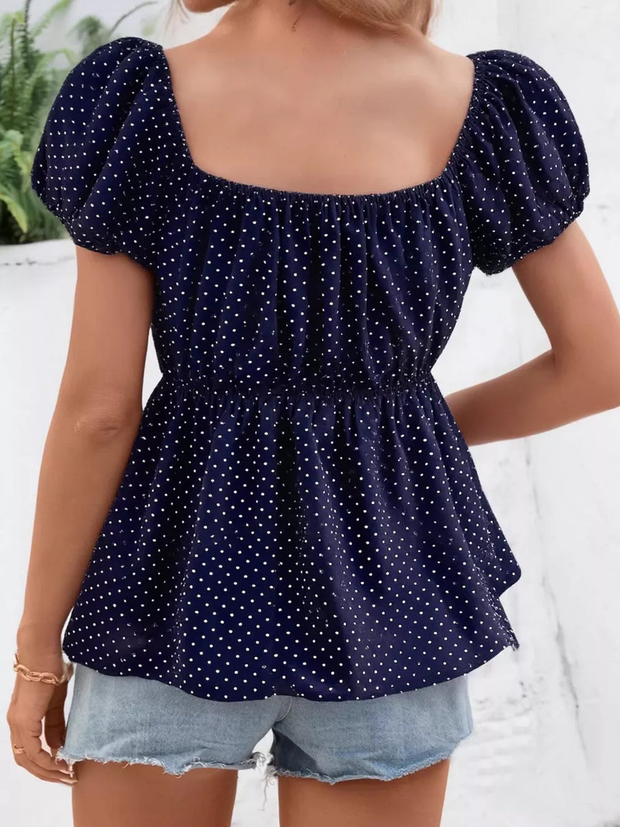 Navy polka dot peplum shirt with puff sleeves and square neckline