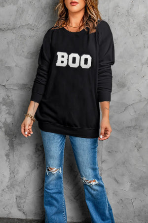 Black crewneck sweatshirt with white varsity "BOO" graphic