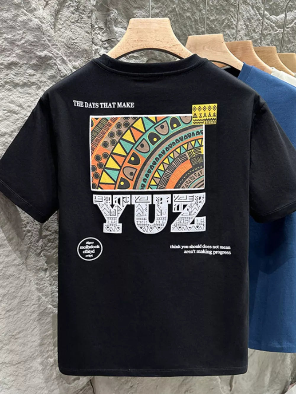 Black cotton crew t-shirt with abstract graphic print and text.