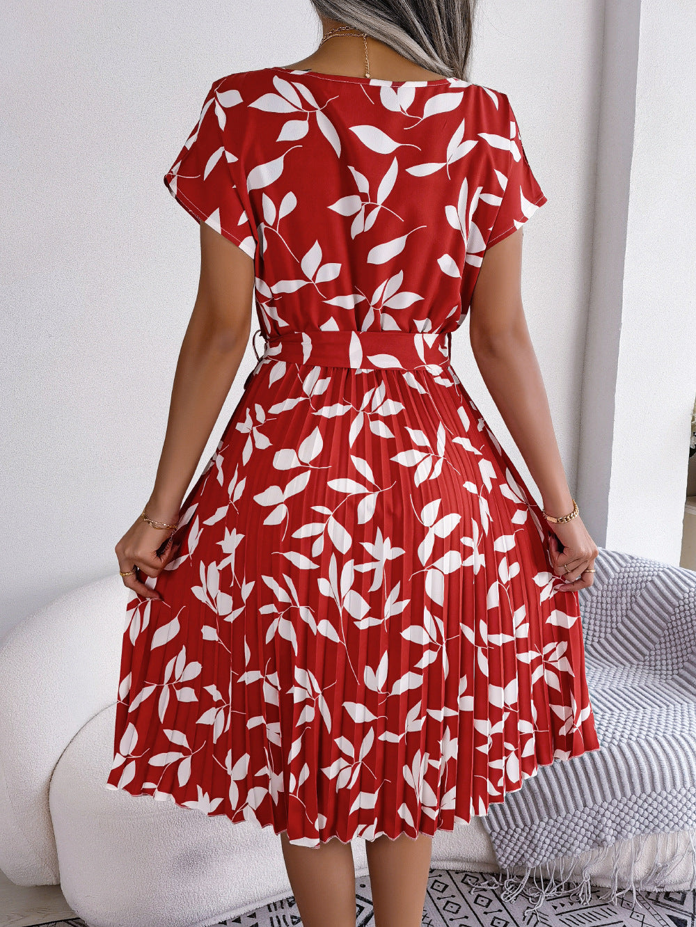 Crimson leaf print midi dress with pleated skirt and short sleeves.