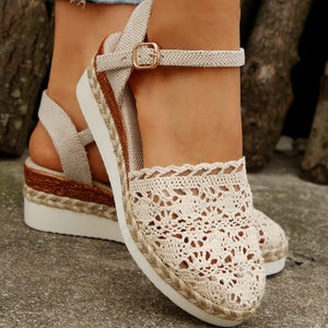 Ivory crochet espadrille sandals with ankle strap and jute-wrapped wedge sole.