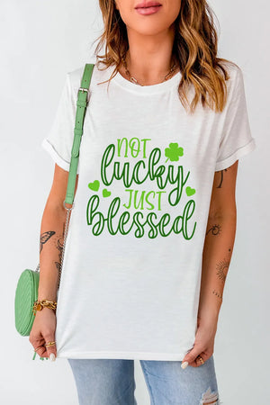 White t-shirt with green text that says Not Lucky Just Blessed and shamrock graphics.