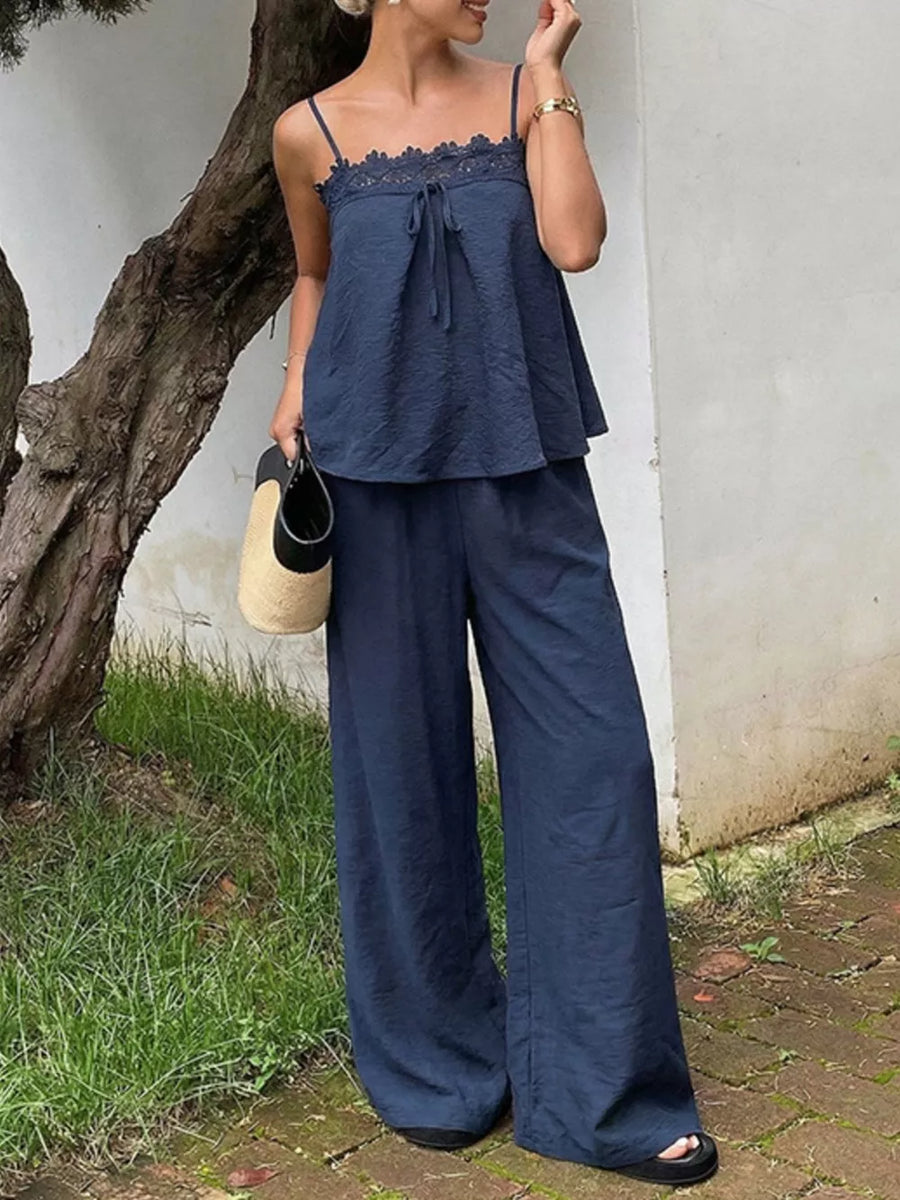 Navy blue cami top with lace trim and tie front, paired with wide-leg pants.