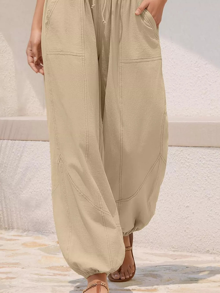 Relaxed harem maternity pants in apricot with drawstring and contrast stitching.