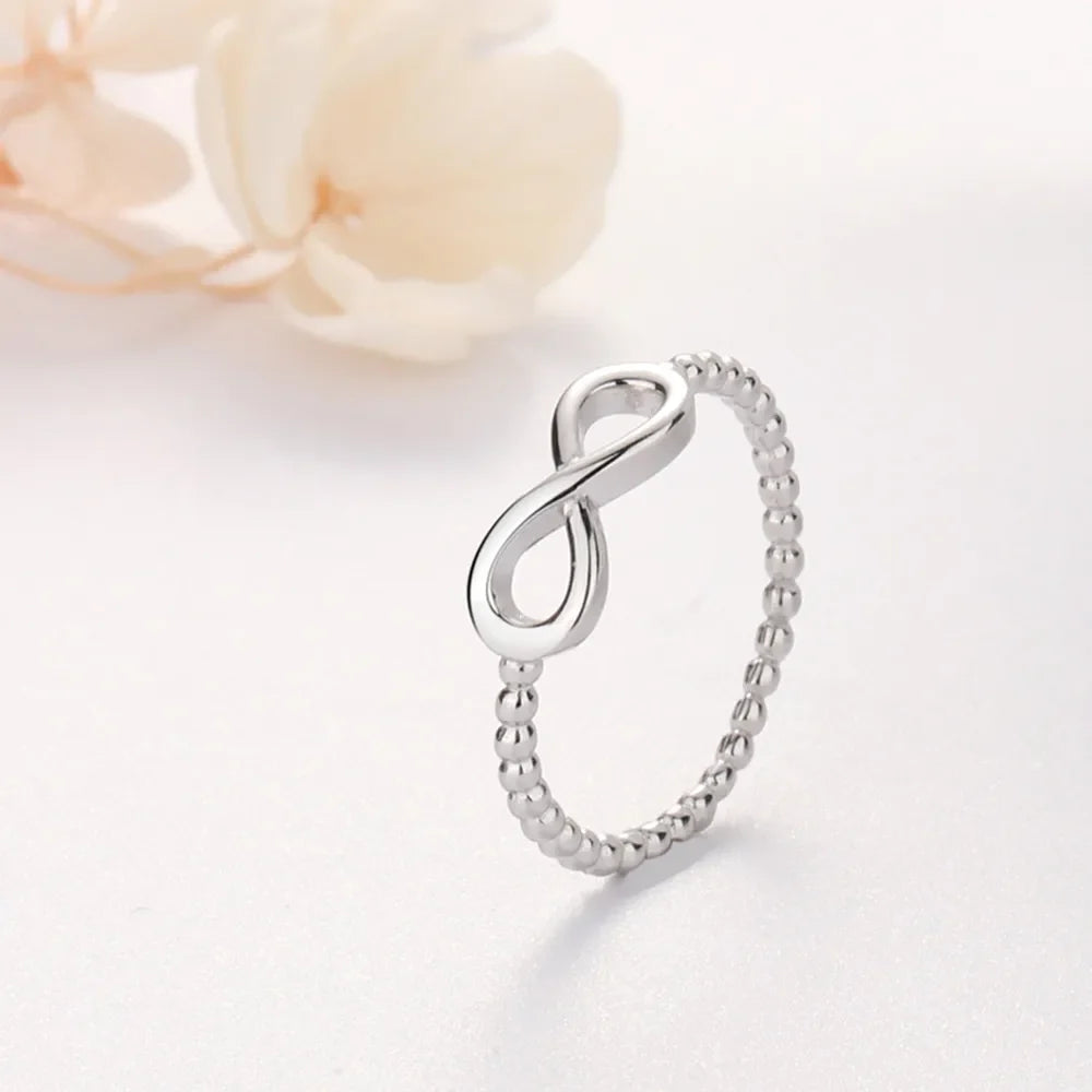 Sterling silver ring with infinity symbol and beaded band