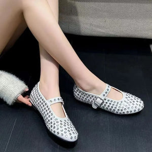 White studded Mary Jane flats with buckle strap detail.