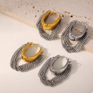 Chunky chain hoop earrings in gold and silver with a textured oval detail.