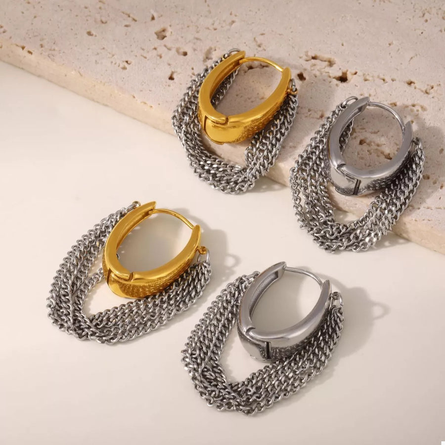Chunky chain hoop earrings in gold and silver with a textured oval detail.