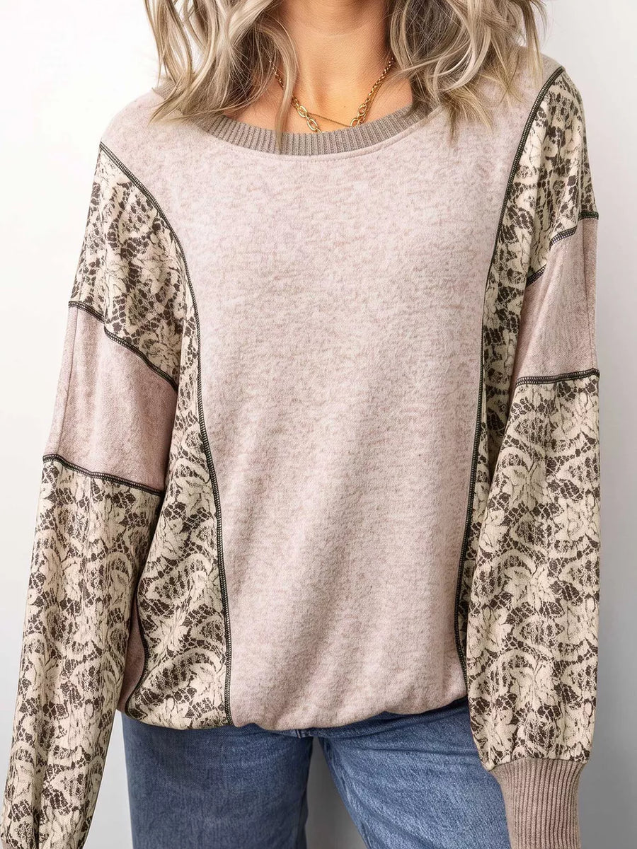 beige blouse featuring ribbed cuffs and floral