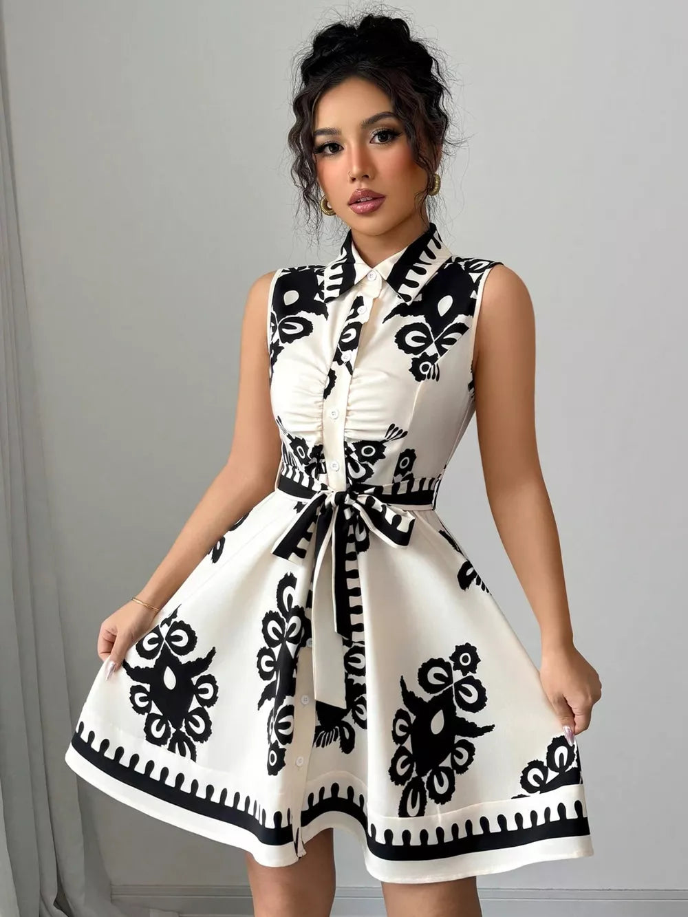 Charming Ruching Tie Waist Dress in black and white print, button-down, collared, sleeveless, A-line skirt.