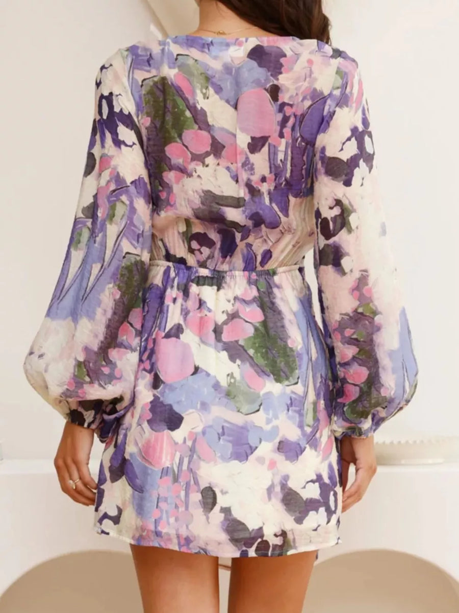 V-neck tie waist dress with abstract floral print and balloon sleeves.