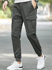 Dark gray cargo joggers with adjustable drawstring waist and multiple zippered pockets.